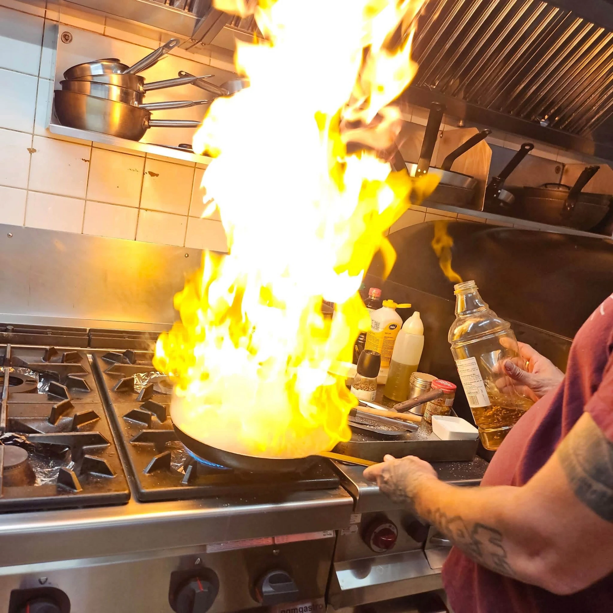 The chef flambéing in the kitchen